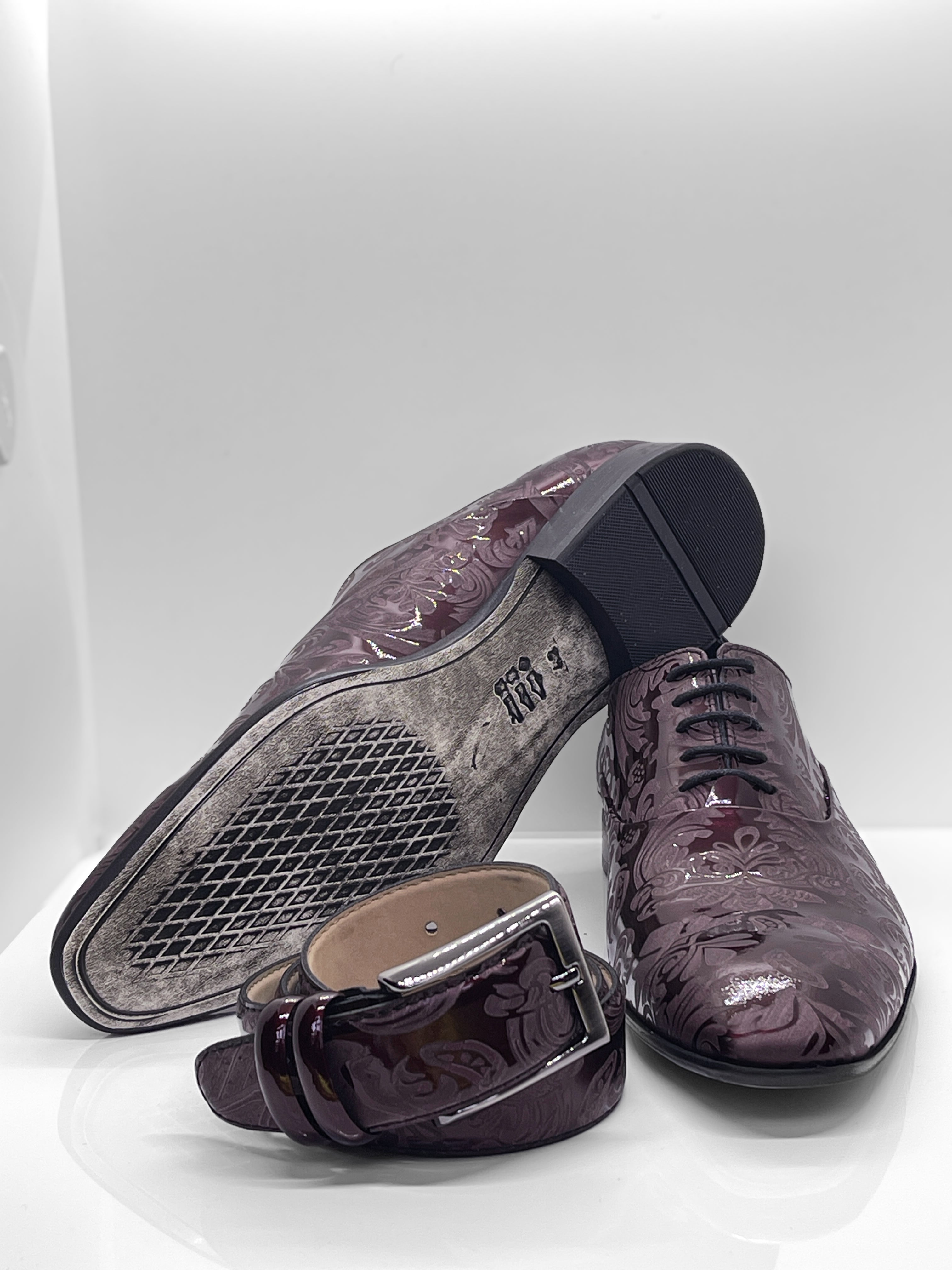 Handgefertigter Herrenschuh aus echtem Leder mit einer filigranen Lasergravur in Form von Paisley-Ornamenten und eleganten Lackleder in Bordeaux